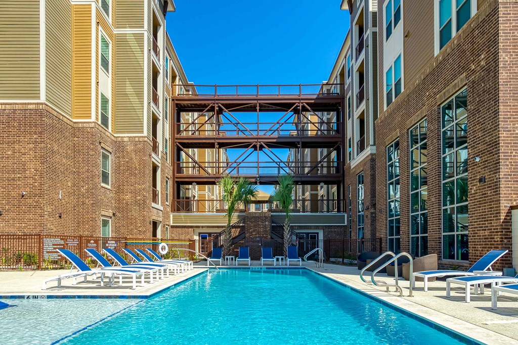 a swimming pool with a building in the background