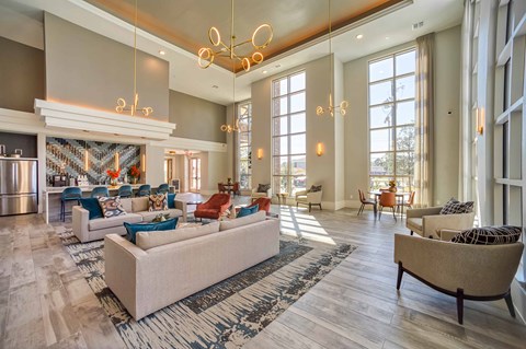 a spacious lobby with couches and chairs and a fireplace
