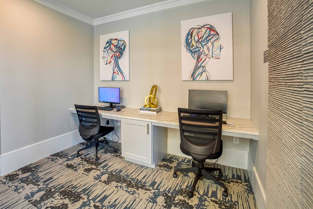 a home office with two desks and a computer