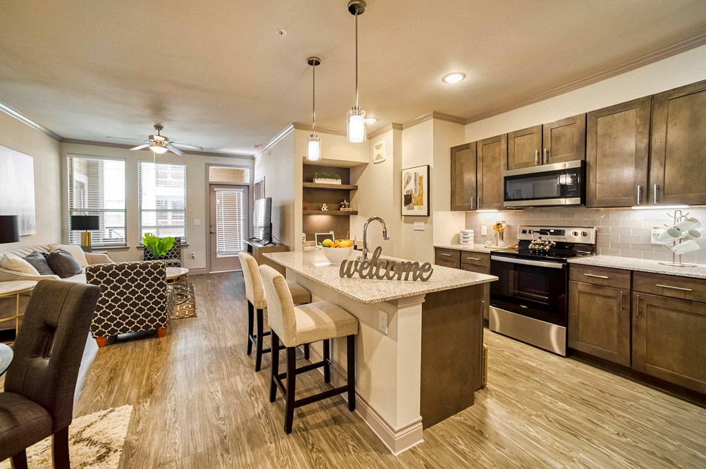 an open kitchen and living room with a large island