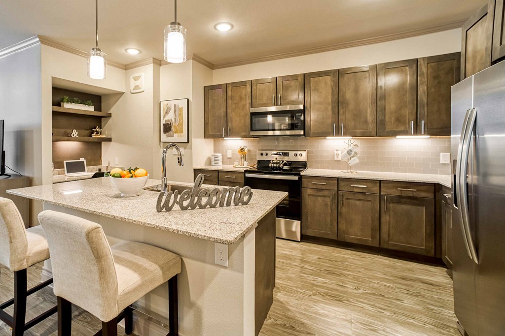 a kitchen with a large island with a counter top