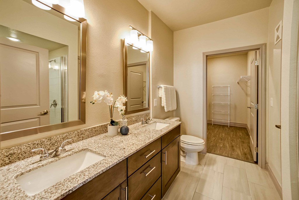 a bathroom with two sinks and a toilet