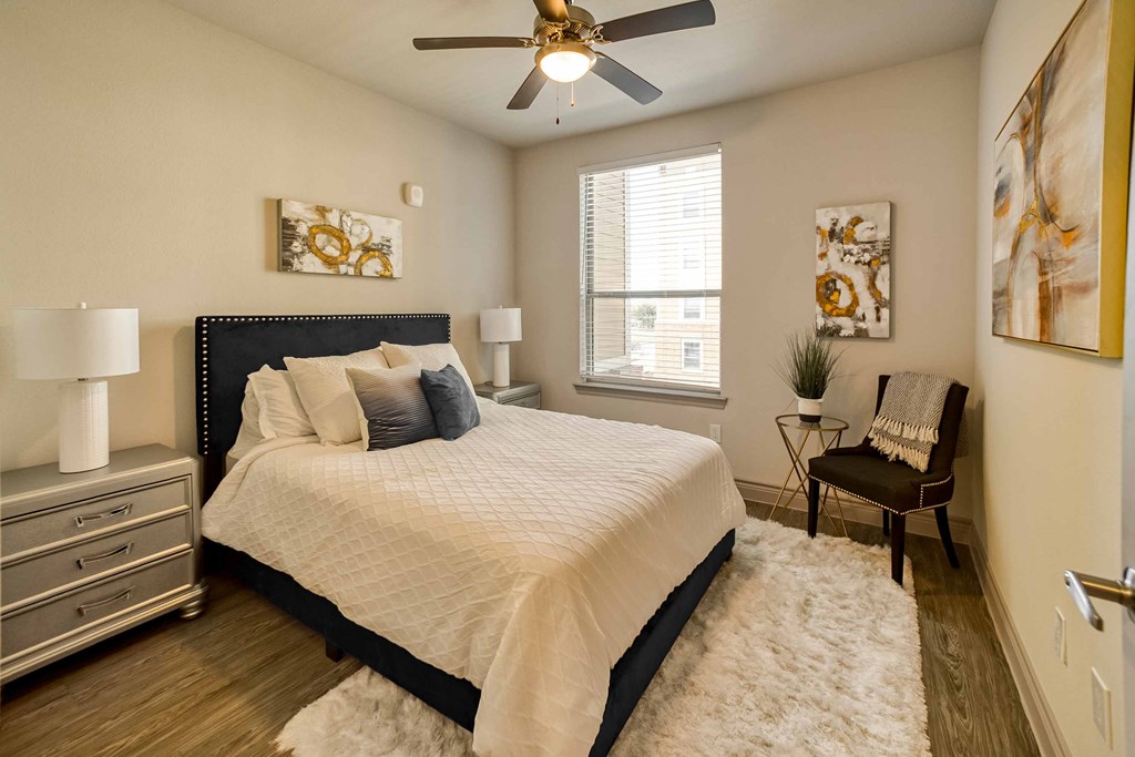 a bedroom with a bed and a ceiling fan