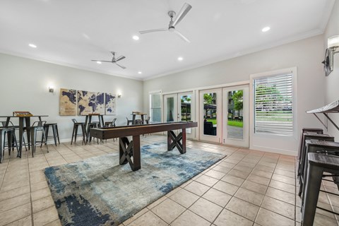 a living room with a pool table and a rug