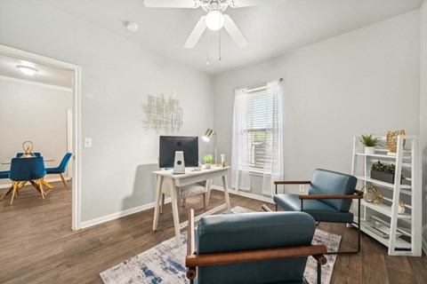 a living room with white walls and a table and chairs