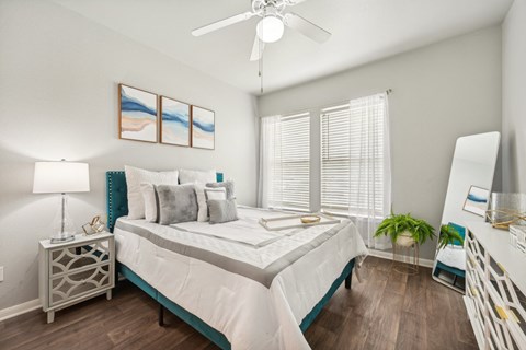 a bedroom with a large bed and a ceiling fan