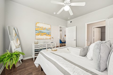 a bedroom with a large bed and a ceiling fan