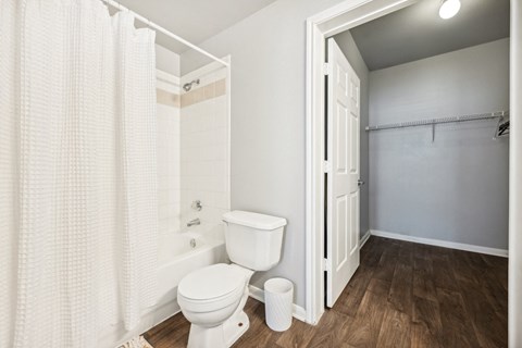 a bathroom with a toilet and a shower with a curtain