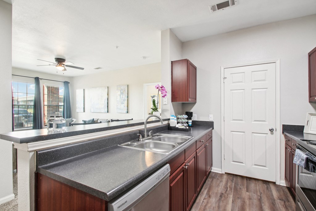 a kitchen with a stainless steel counter top and a sink
