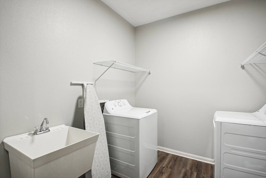a white bathroom with a sink and a tub and a mirror