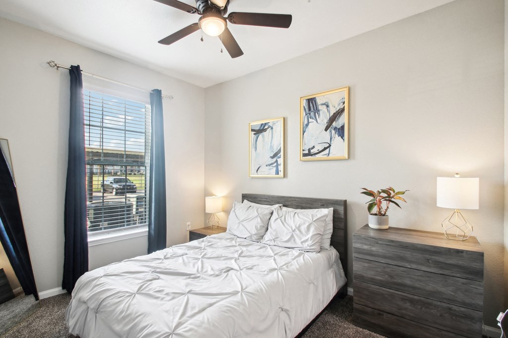 a bedroom with a bed and a ceiling fan