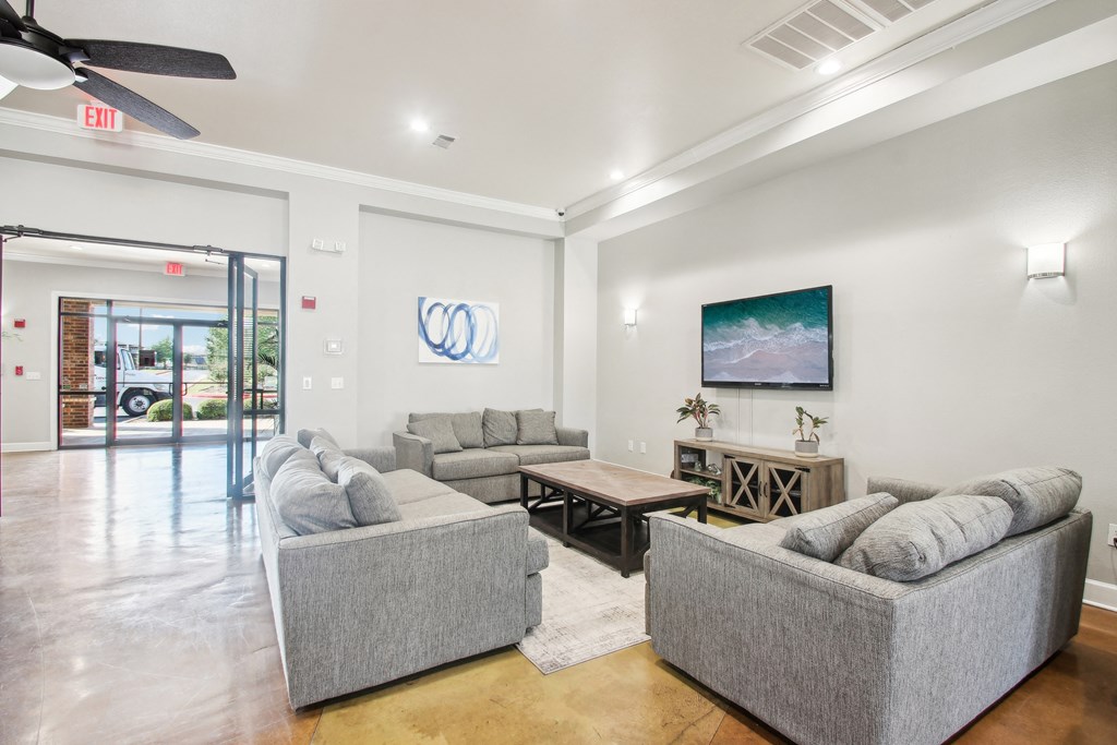 a living room with couches and a coffee table and a tv