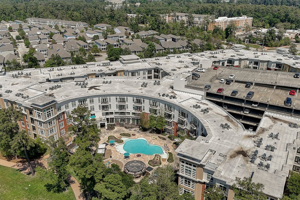 an aerial view of a building with a swimming pool