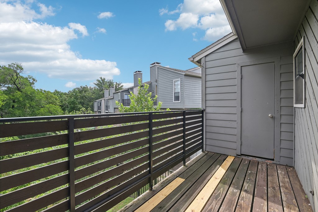 the deck of a home with a door to the backyard