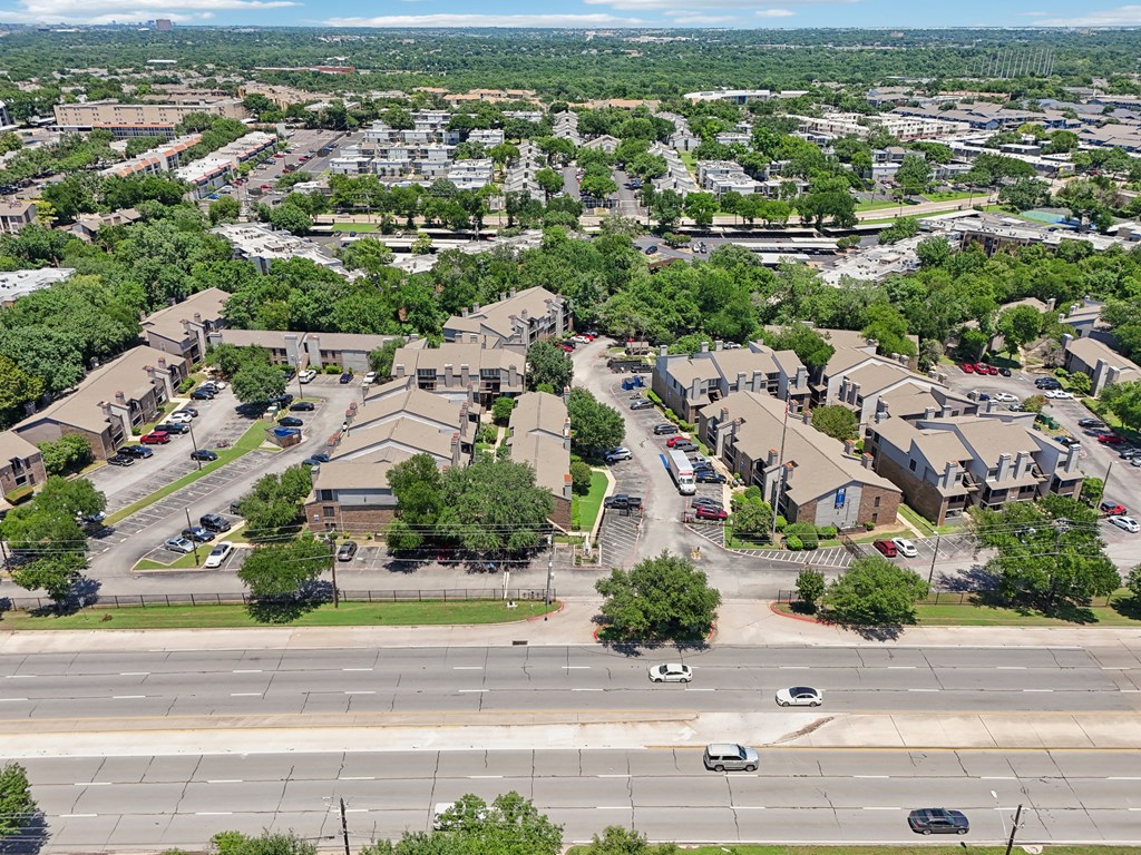 an aerial view of a suburban neighbourhood with cars parked on the street