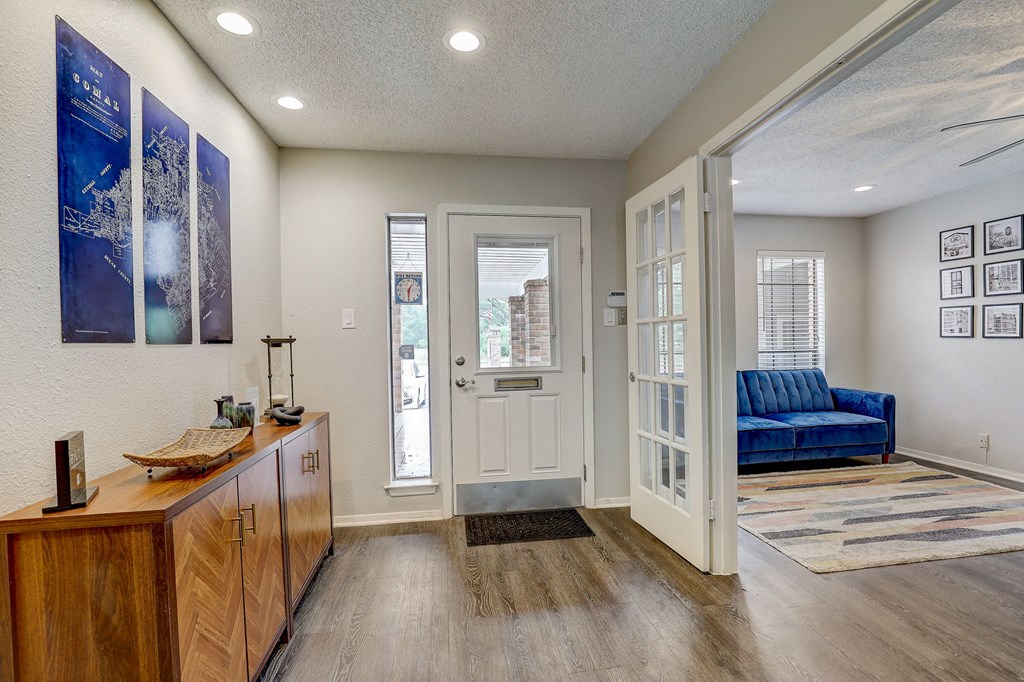 a living room with a white door and a blue couch