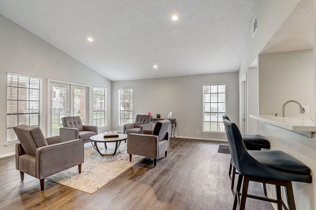 a living room with couches and chairs and a table