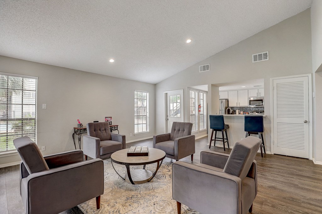 a living room with couches and chairs and a table