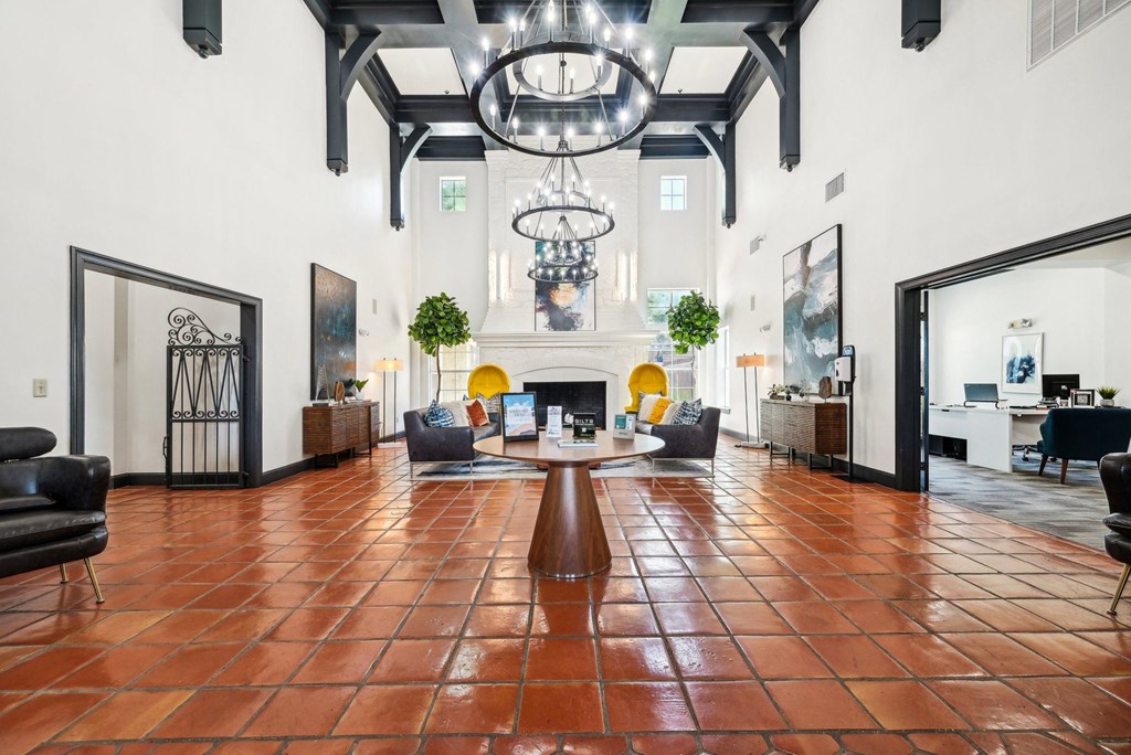 a large living room with a fireplace and a large chandelier