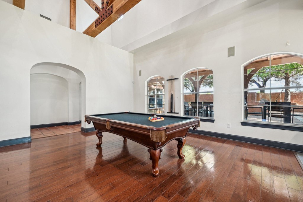 a room with a pool table in the middle of it