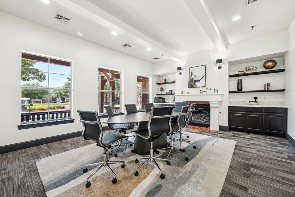 a conference room with a table and chairs and a fireplace