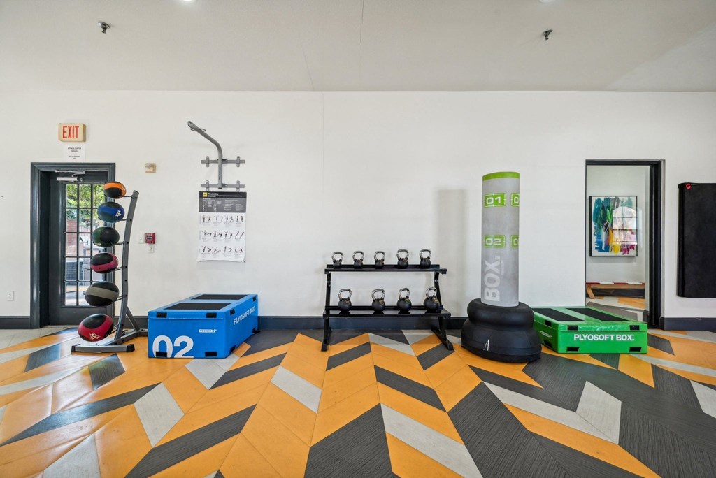 a fitness room with weights and other gym equipment