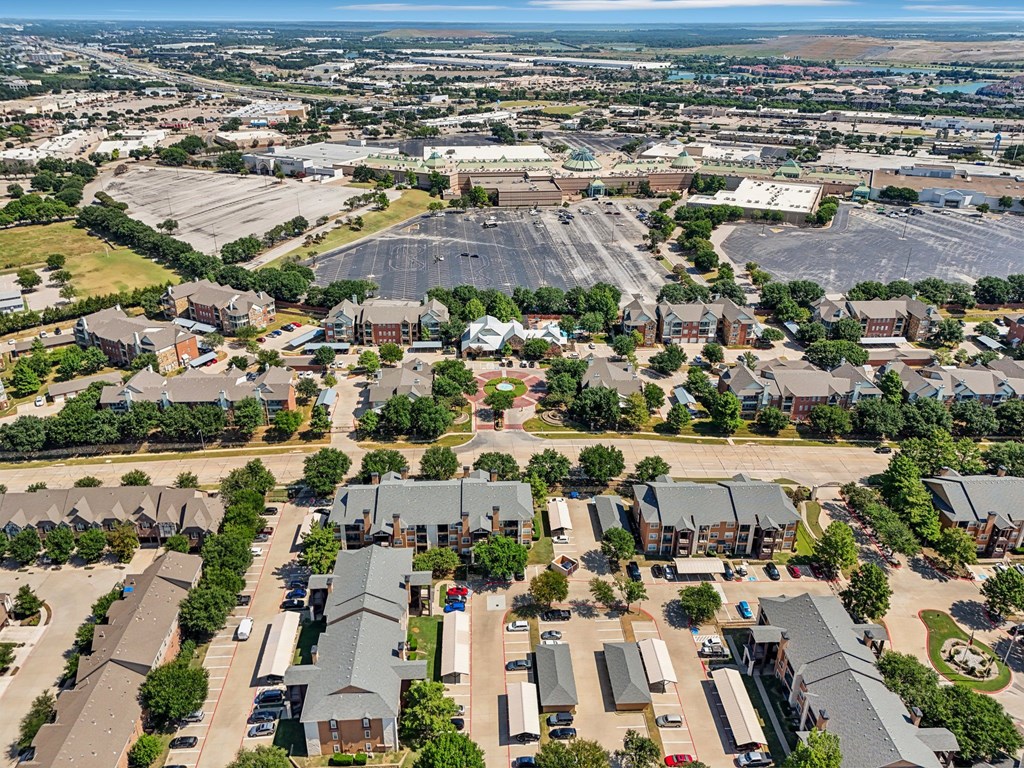 an aerial view of a suburb of a city with a large parking lot