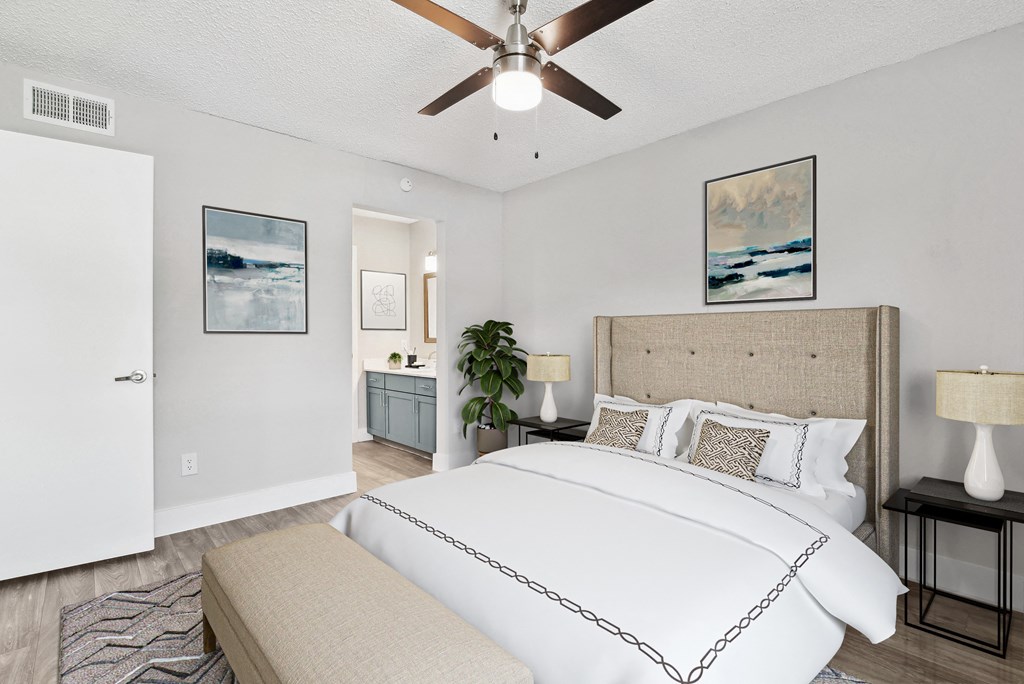 a bedroom with a bed and a ceiling fan