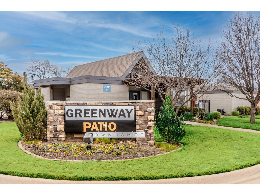 a home with a sign for greenway pahoehoe in the front yard