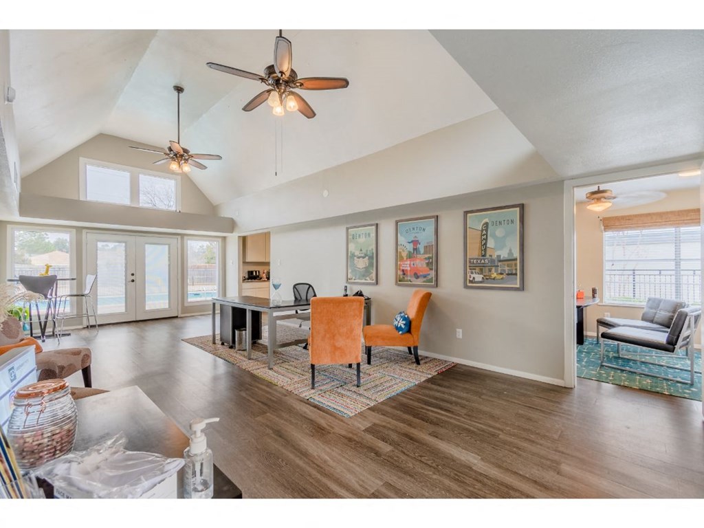 a living room and dining room with a ceiling fan