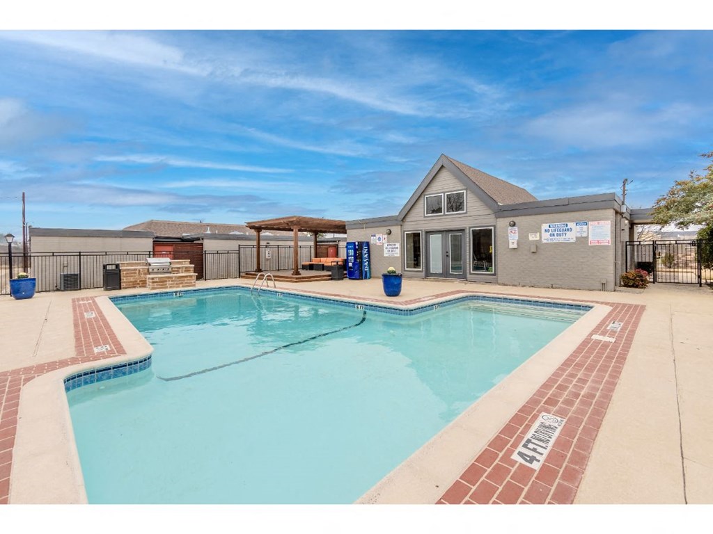 a large pool with a house in the background