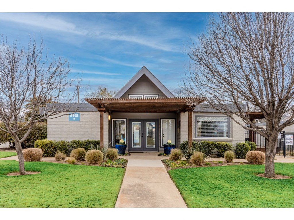the front of a house with a sidewalk in front of it