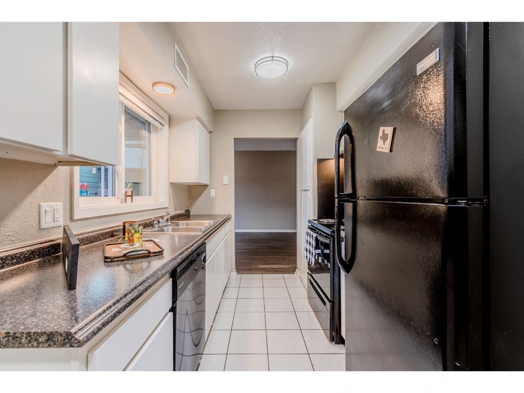 a kitchen with a counter top and a refrigerator