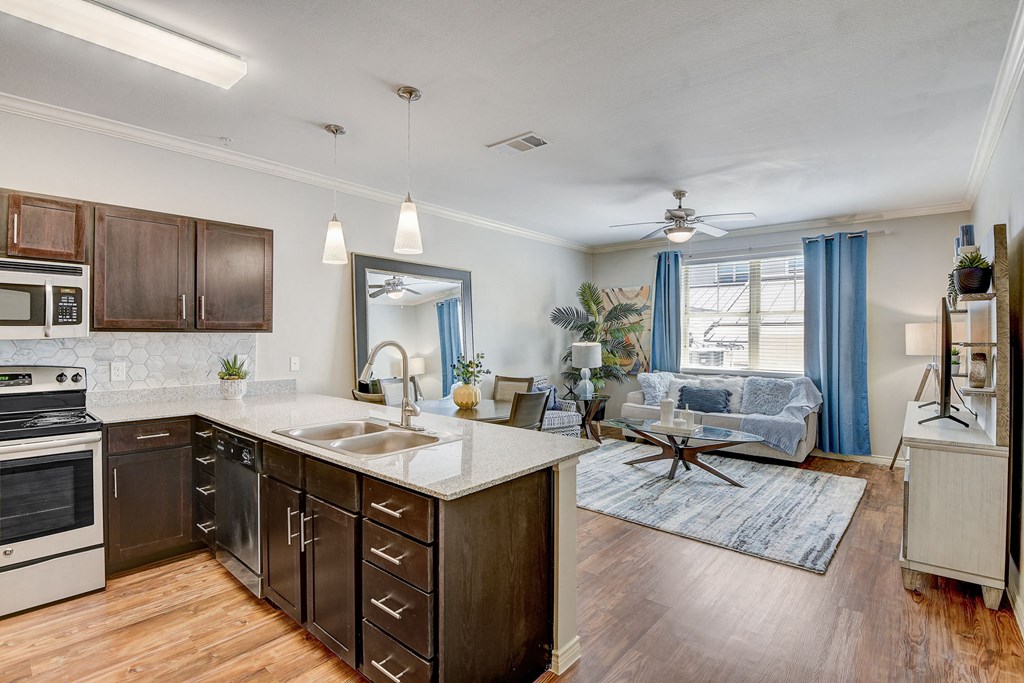 the view of a kitchen and living room with a large window