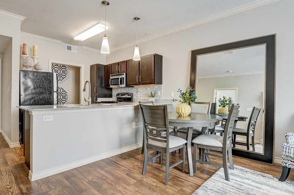 an open kitchen and dining area with a table and chairs