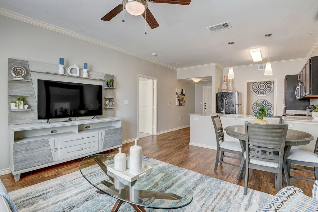 a living room with a tv and a table and chairs