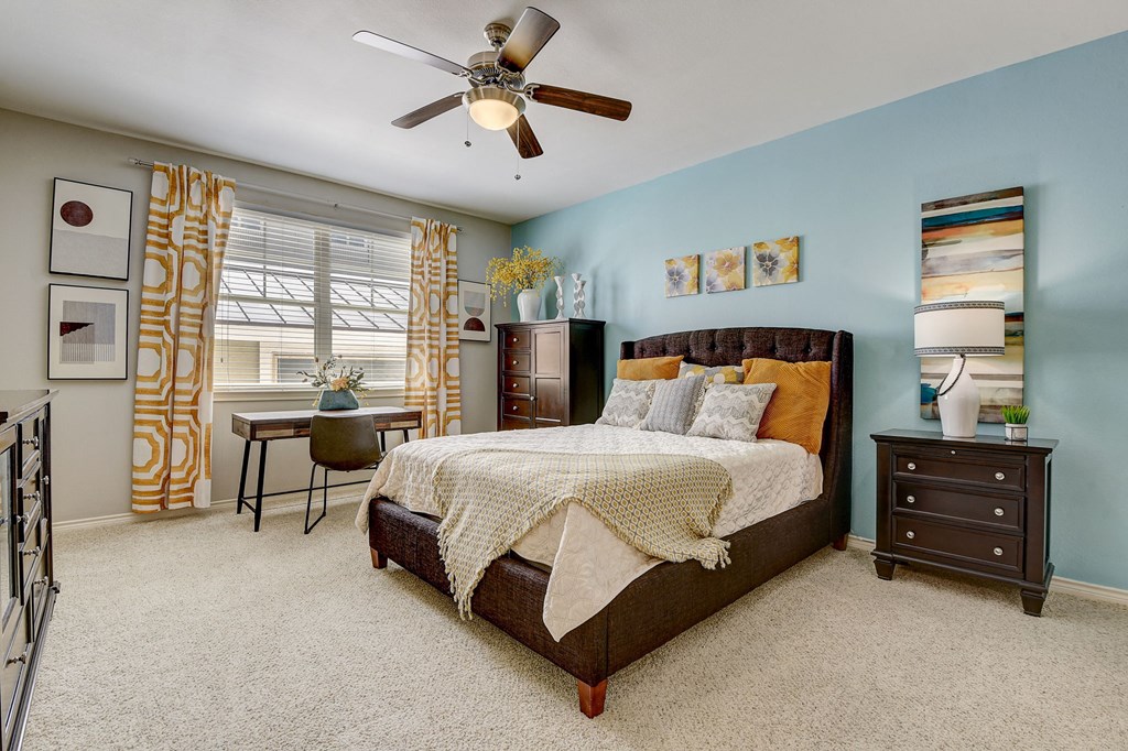 a bedroom with a bed and a ceiling fan
