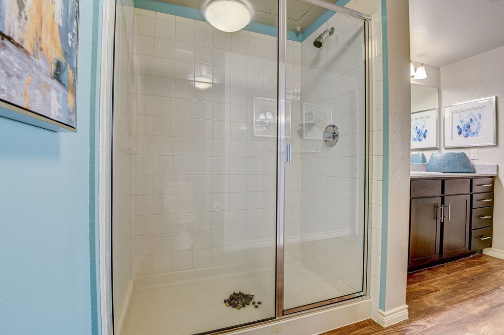 a shower with a glass door in a bathroom