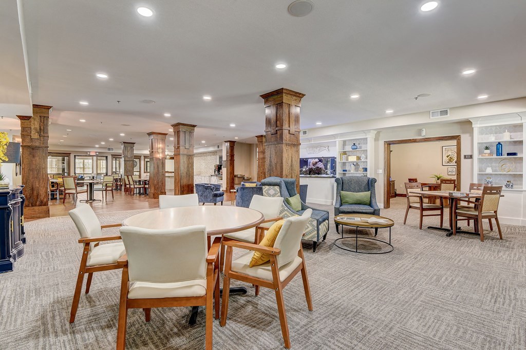 a large room with tables and chairs in a lobby