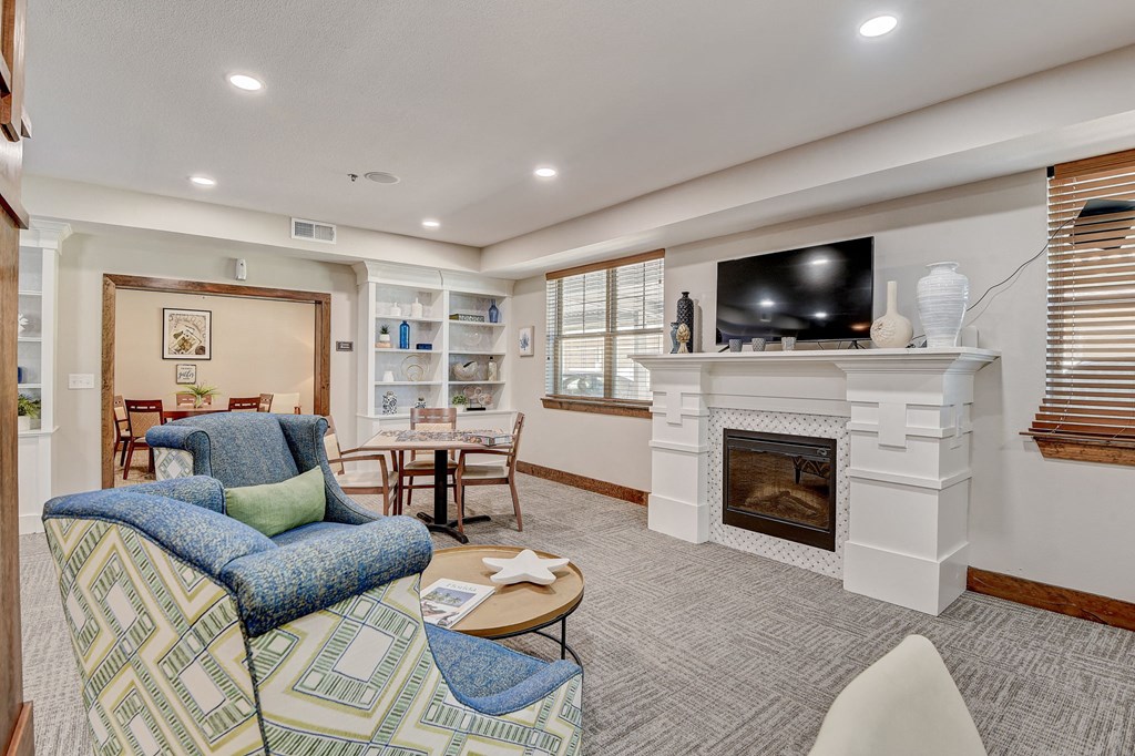 a living room with a fireplace and a tv