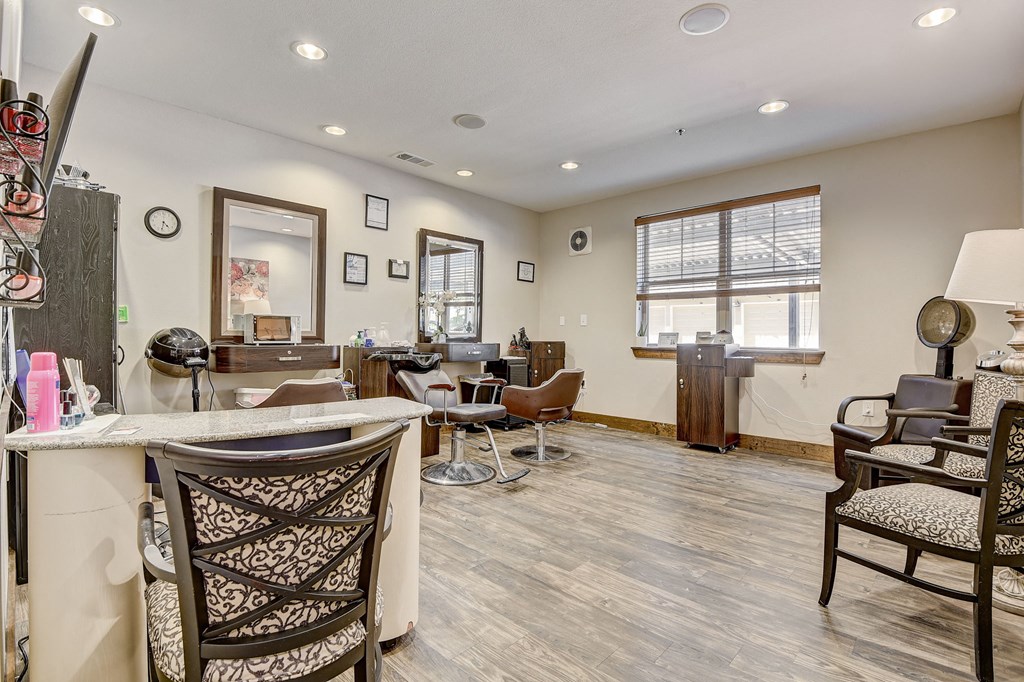 a living room with a bar with chairs and a counter top