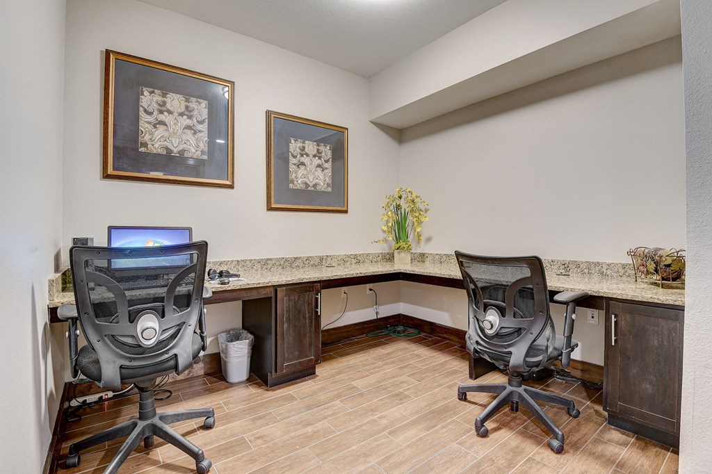 a home office with two desks and two chairs