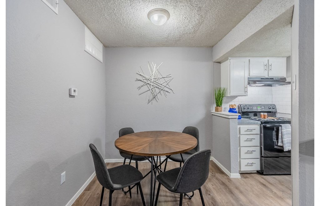 a dining room with a table and chairs and a kitchen