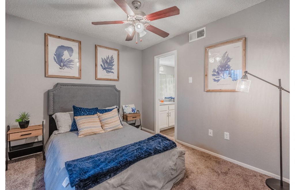 a bedroom with a bed and a ceiling fan