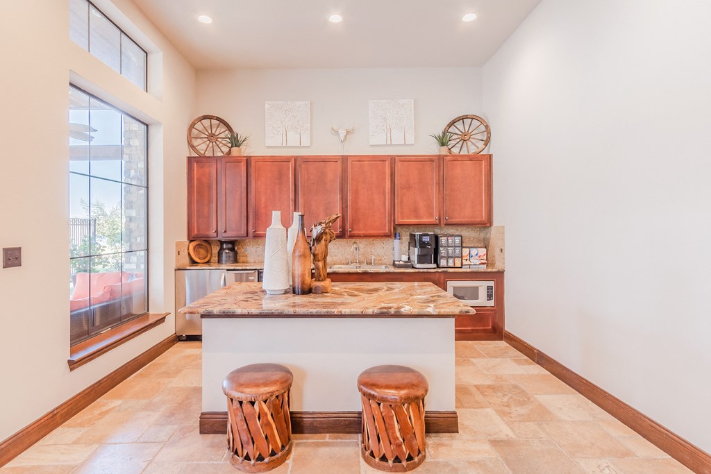 a kitchen with wooden cabinets and a counter with stools