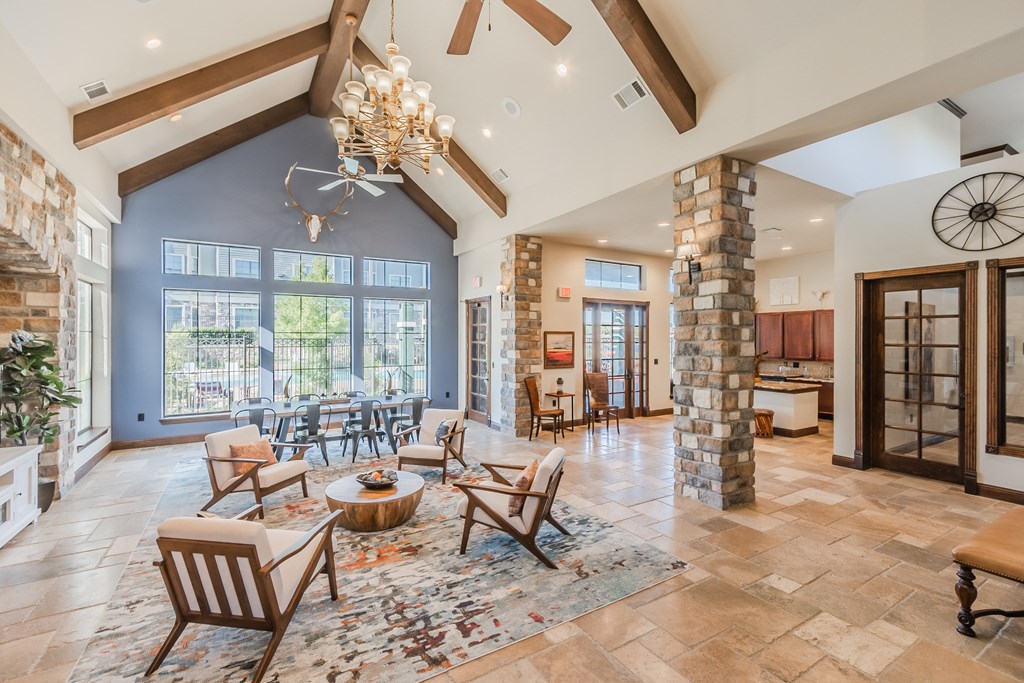 a living room with chairs and a table and a fireplace