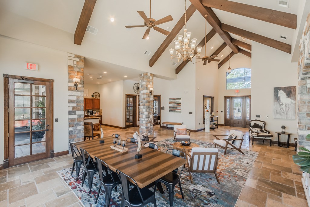 a large dining room with a wooden table and chairs