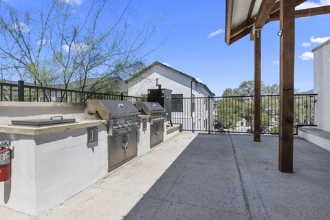 the 2400 2400 series stainless steel gas grills in the patio area of a house