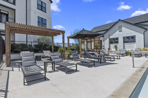 the estates with lounge chairs and umbrellas