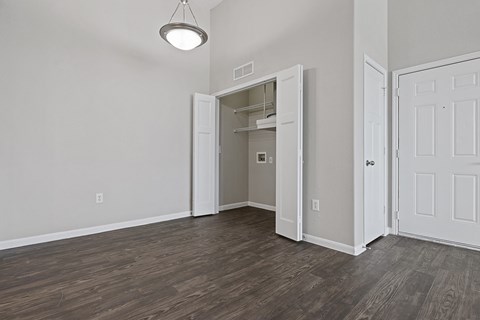 A room with a white door and a light on the ceiling.
